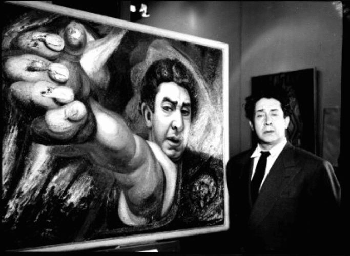 David Alfaro Siqueiros next to his painting entitled El Coronelazo.