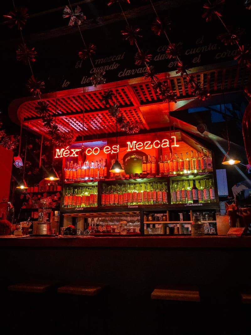 A bar serving mezcal in Mexico at night.