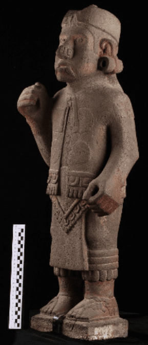 Anthropomorphic standard-bearer sculpture, featuring an individual adorned with elements associated with Xiuhtecuhtli (god of fire).
