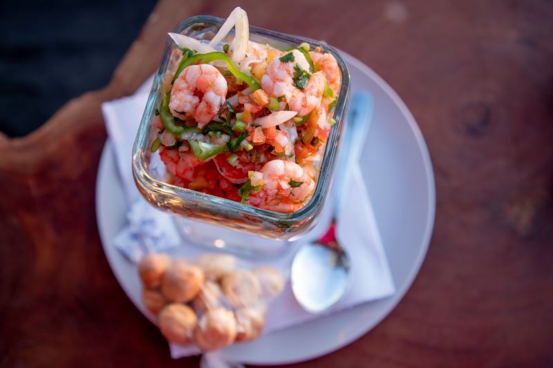 Ceviche is a dish composed of fresh seafood, citrus juice, onions, peppers, and seasonings.