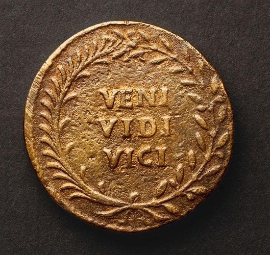 Bronze sestertius with the phrase "Veni, Vidi, Vici" printed on its reverse.