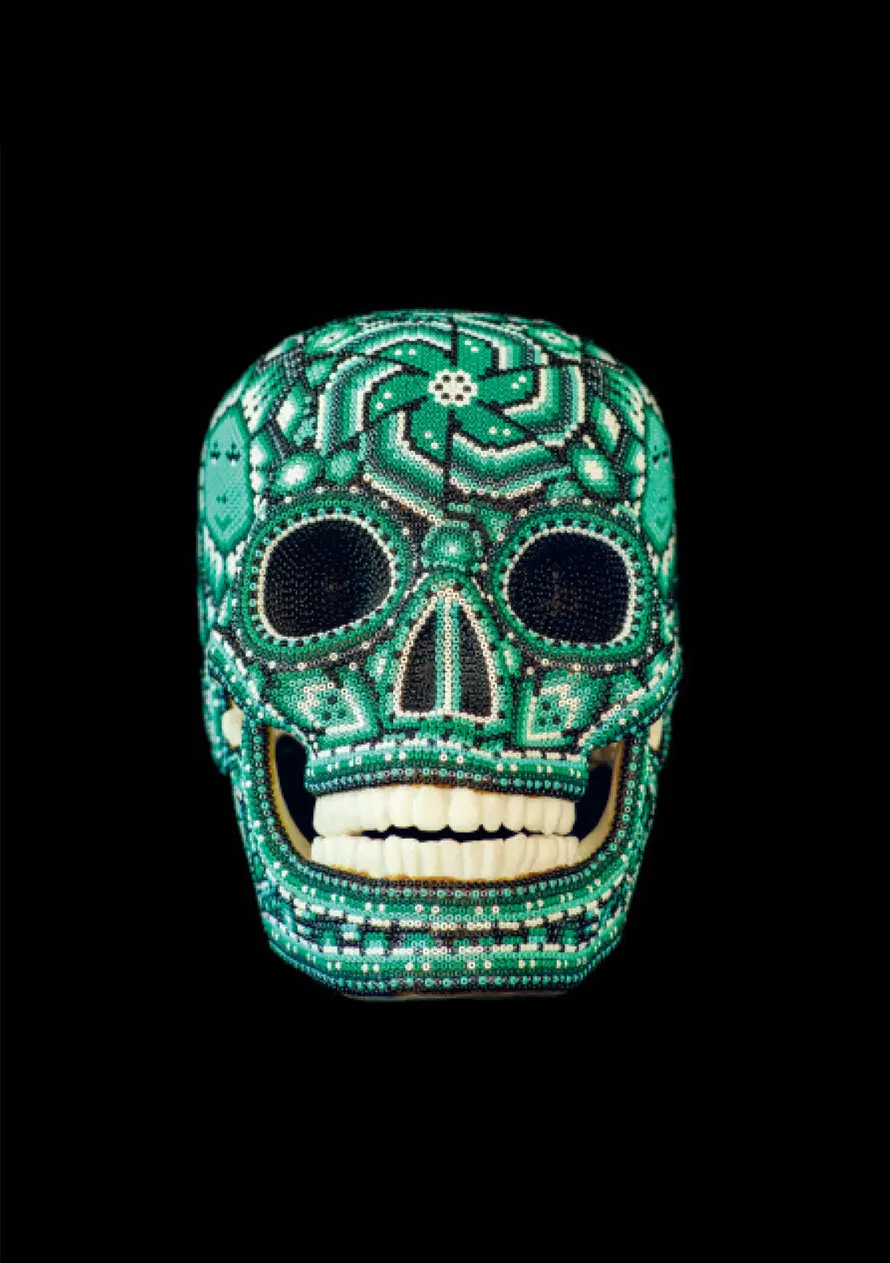 An intricate Huichol skull showcases the vibrant colors and sacred symbols of Wirraritari culture.