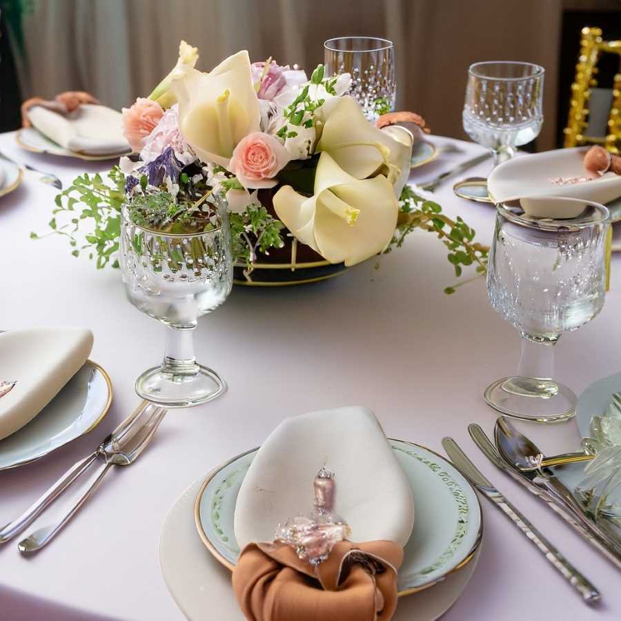 A beautifully arranged table set with exquisite china and elegant floral centerpieces.