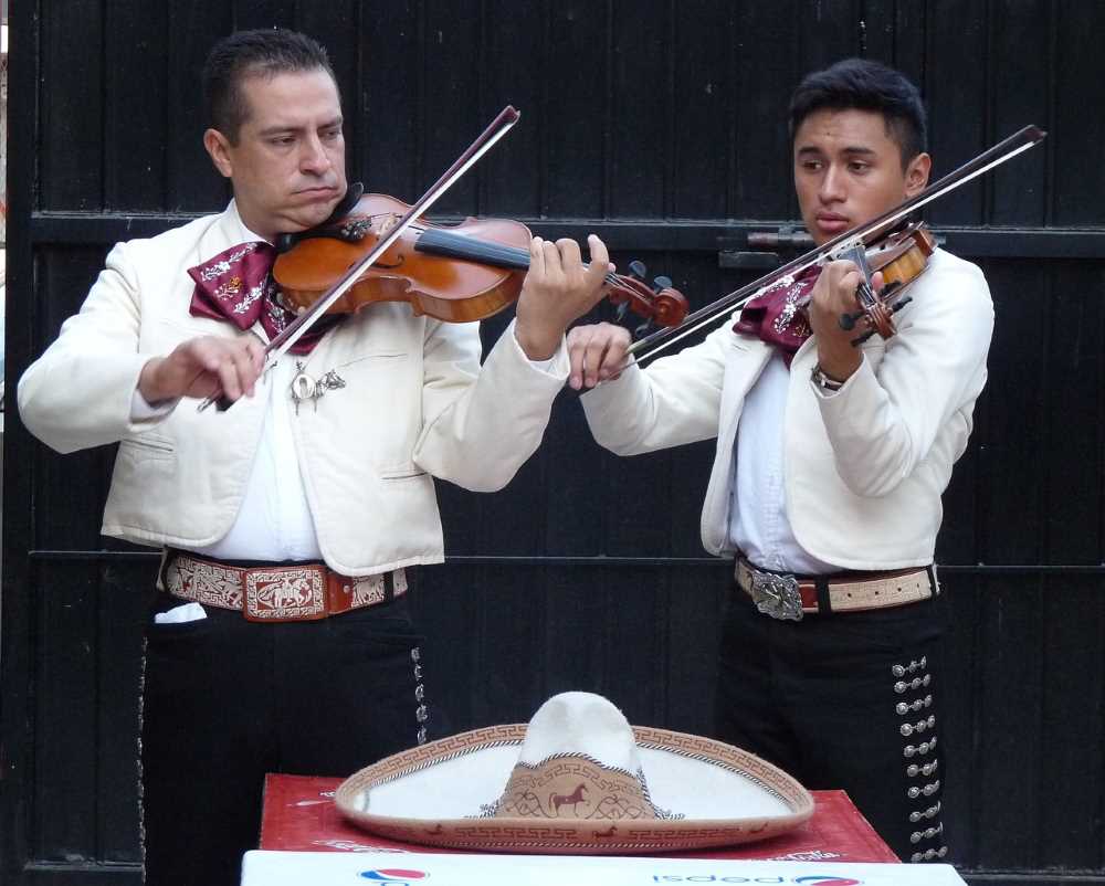 Mariachis perform at a traditional Mexican festival, showcasing the country's music and traditional costumes.