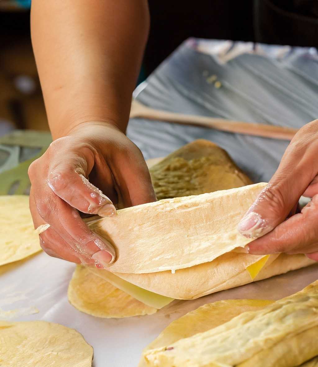 A hands-on approach to tamale-making, filling, and wrapping each tamale.