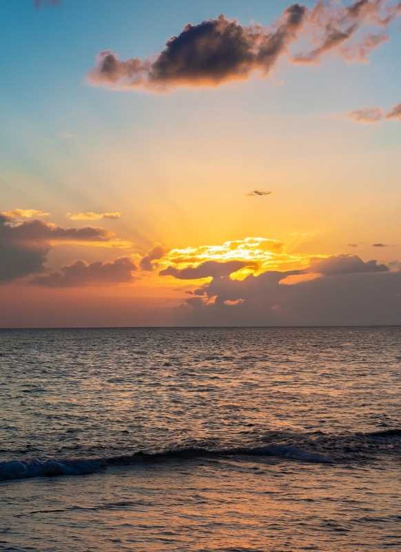 Sunset over Cancun's stunning beaches, where tourists seek experiences.