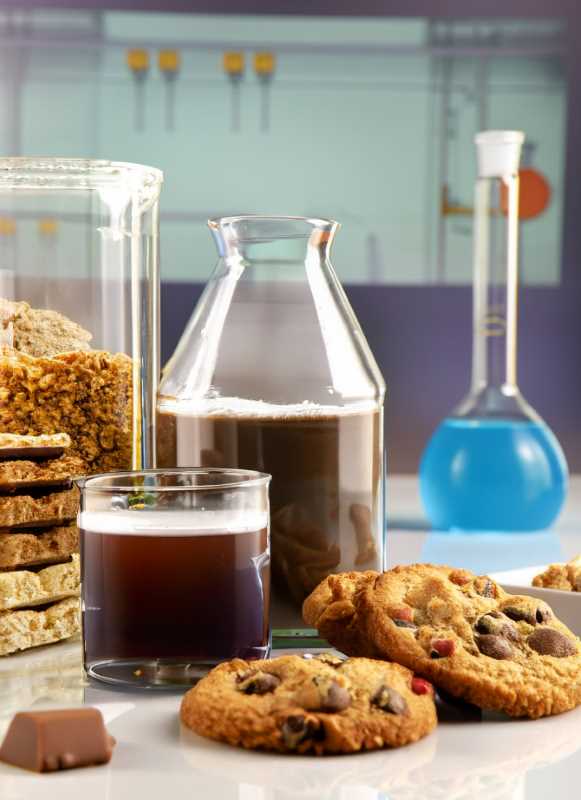 Beverages, cookies, and nutritional bars, set against a laboratory backdrop.