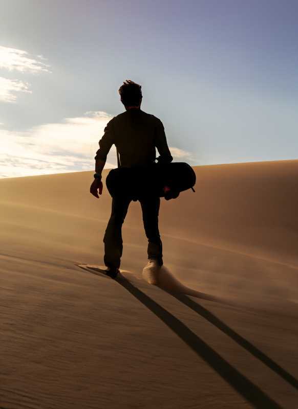Adrenaline meets natural beauty: A sandboarder takes on the majestic dunes of Los Algodones.