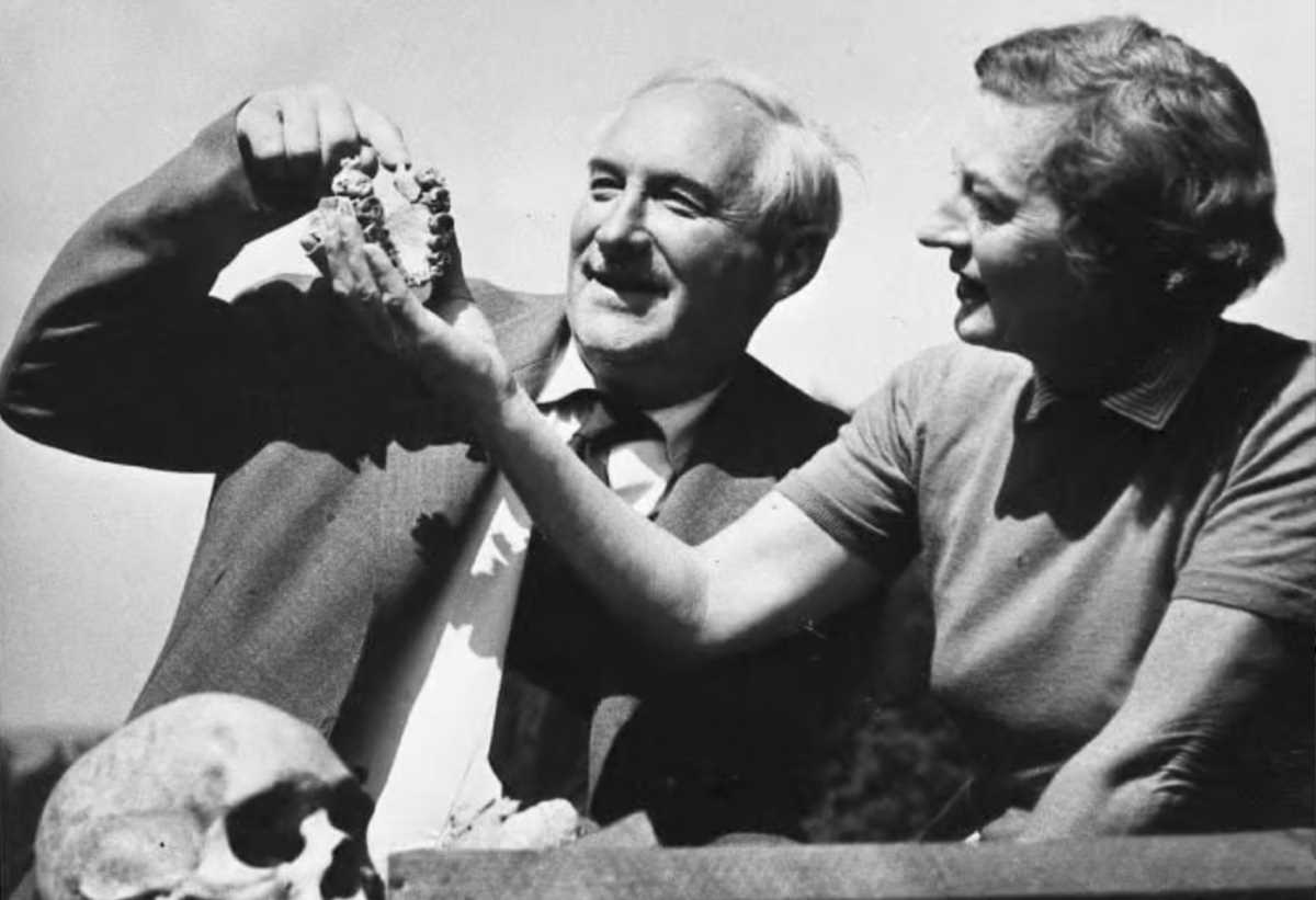Louis Leakey posing with the Nutcracker Man fossil in the Olduvai Gorge.