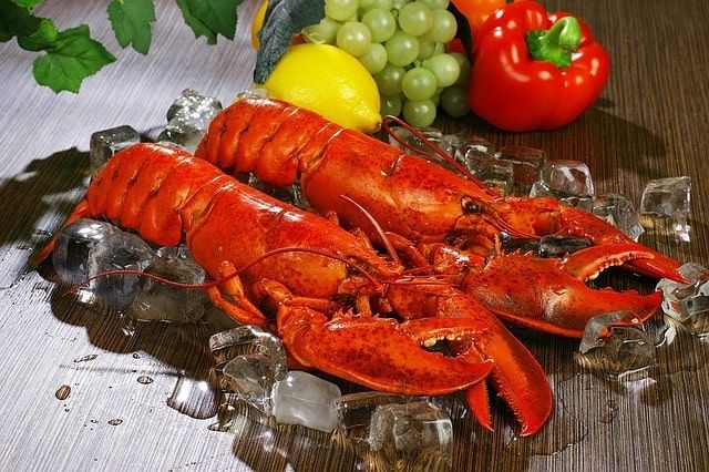 Why do lobsters, shrimp, and crabs turn red when cooked?