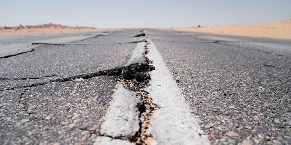 When an earthquake strikes, what should you do if you're driving?