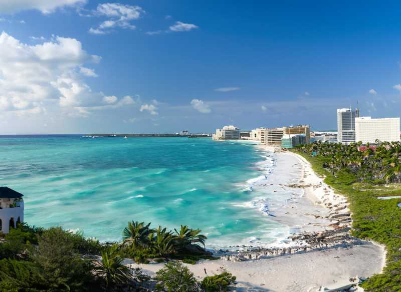 A panoramic view of Cancun's dazzling coastline, a testament to the city's explosive growth and evolving challenges.