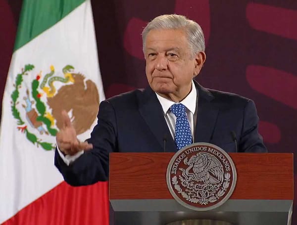 President López Obrador stands at a podium, gesturing triumphantly, with the Mexican flag behind him.