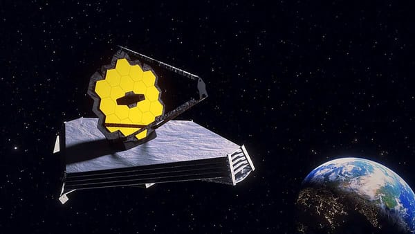 Image of the James Webb Space Telescope with its gold-plated hexagonal mirrors and sunshield deployed.