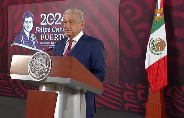 President López Obrador stands at a podium speaking to a crowd, symbolizing Mexico's Morning Conference.