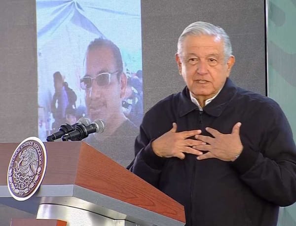 President López Obrador speaking at a podium during the Morning Conference, advocating for women's rights.