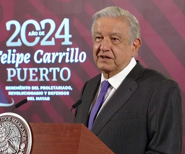 President López Obrador stands at a podium addressing the nation, symbolizing leadership and governance.