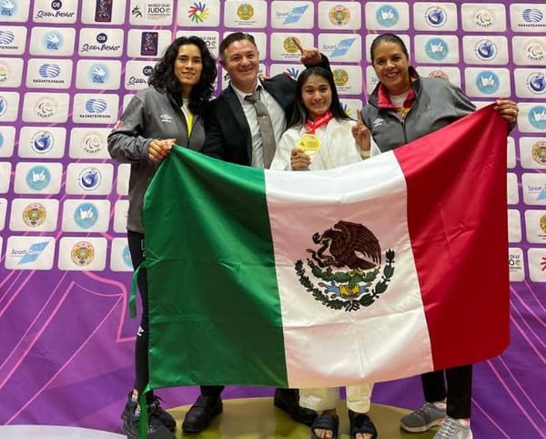 María Isabel Huitrón Ángeles, a judo champion, stands proudly with her gold medal.