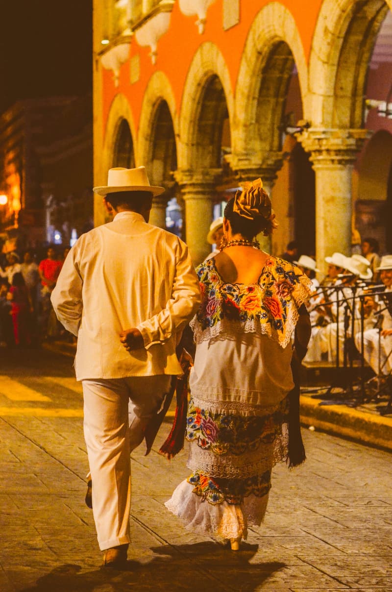 A couple walking down the street during festivities in Mérida, Yucatan, Mexico.