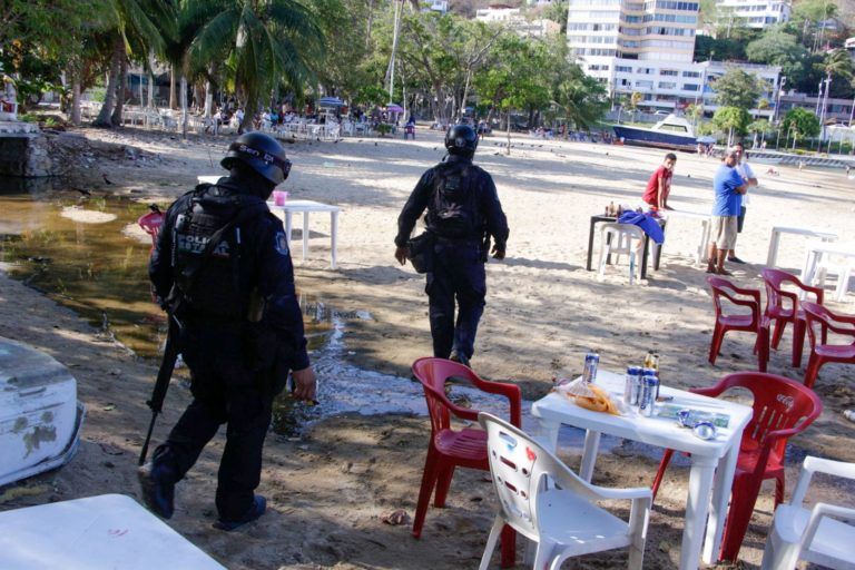 Police officers are seen on the scene after shooting in Acapulco.