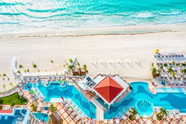 A beach in Cancun and luxury hotel development for a happy vacation.
