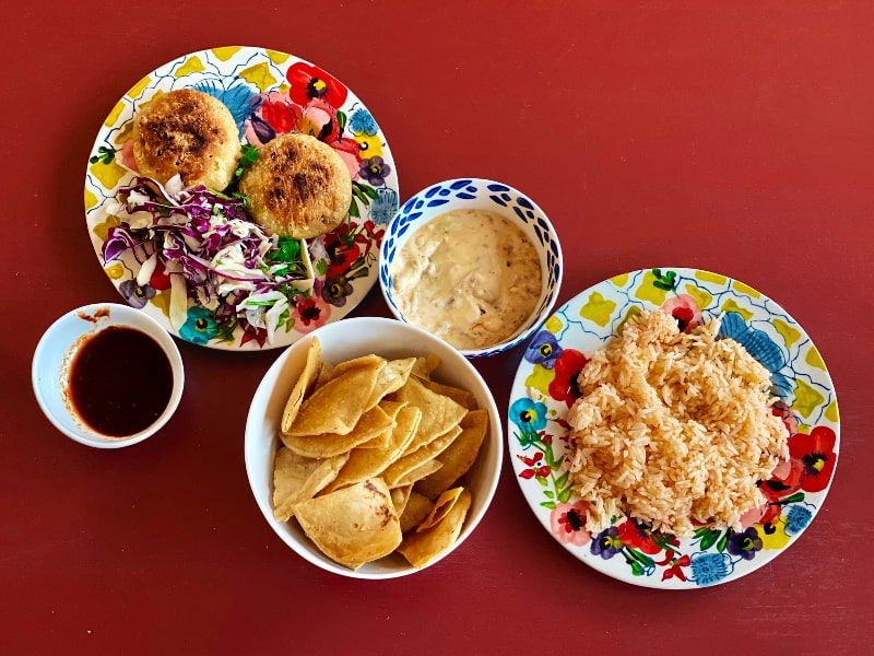 Plates with Mexican dishes, dips and salsas.