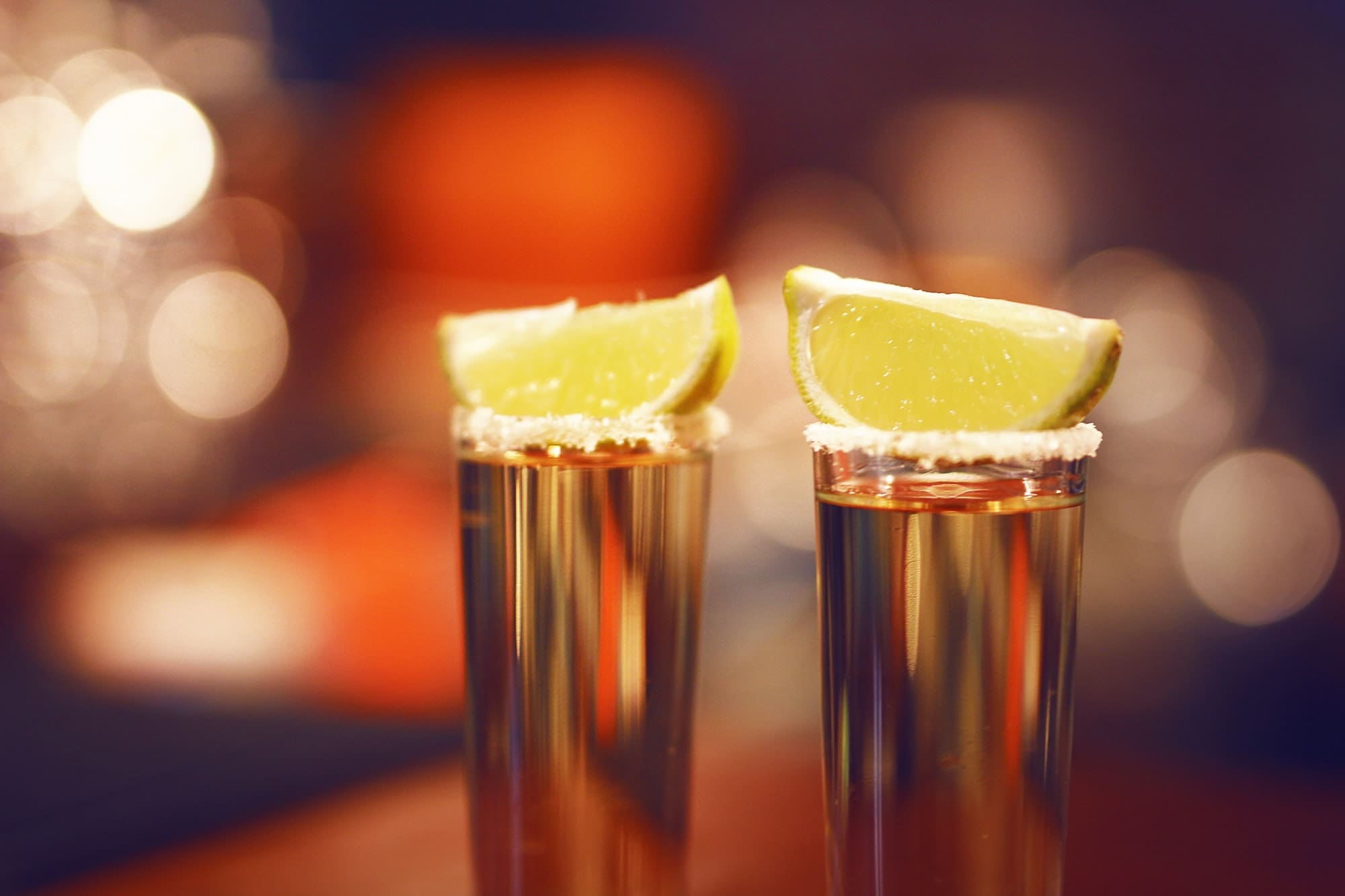 Two tequila shots with salta and lime.