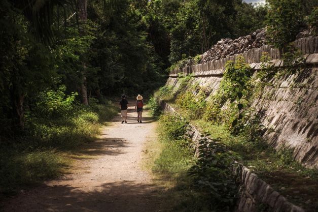 Tourists can be seen touring the ancient Mayan Route ruins on foot.
