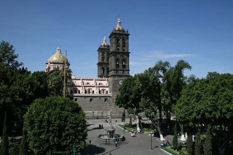 The central square of the city of Puebla is surrounded by beautiful gardens and colonial buildings.