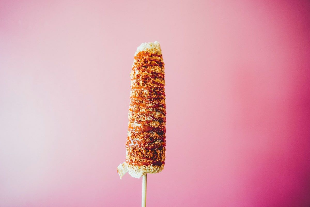 Mexican Elotes, Served with Mayonnaise, Cheese, and Chili.