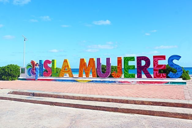 When traveling from Cancun, what is the best method of transportation to reach Isla Mujeres?