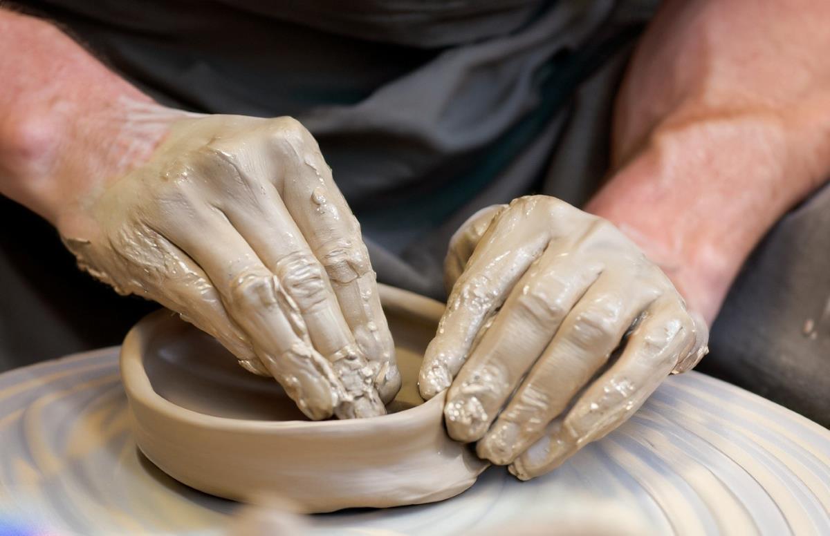 An artisan's skilled hands breathe life into clay, creating vibrant and intricate Mexican pottery.