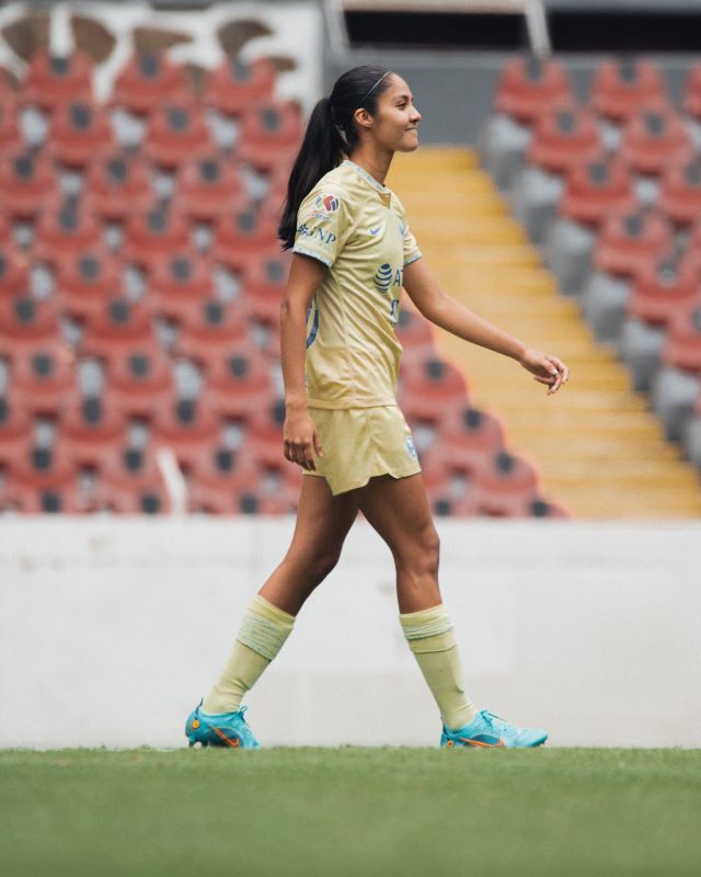Alison González celebrates her milestone as she scores her hundredth career goal.