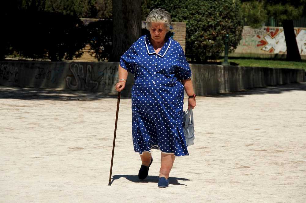 Captured mid-step, an elderly woman walks with purpose, defying societal stereotypes in Mexico.