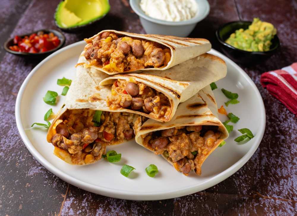 Tortilla wraps filled with refried beans, ground beef, and boiled eggs are a delicious and easy-to-make meal.